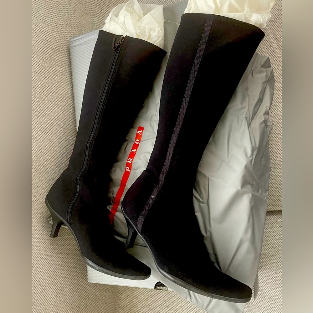 Knee high black Prada boots.